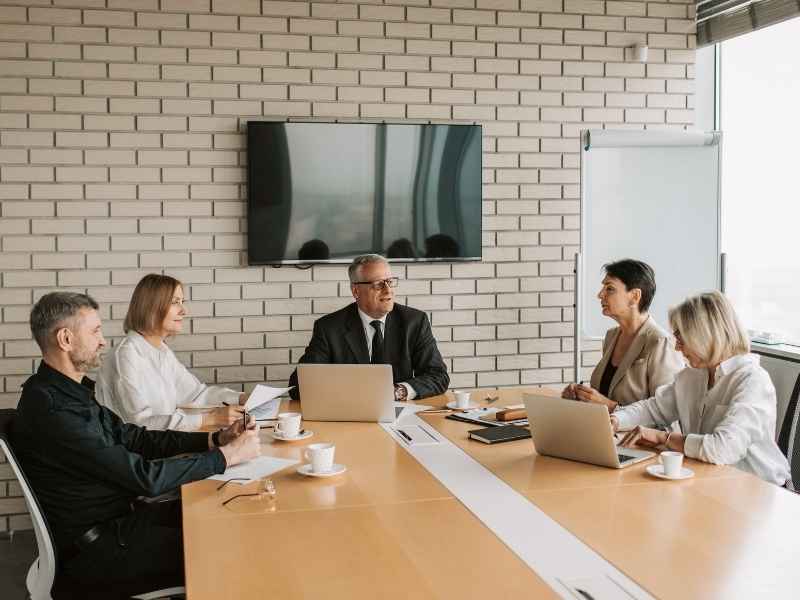 Business leaders in a boardroom discussing long-term strategy and governance reforms aimed at building investor confidence in Latin America.