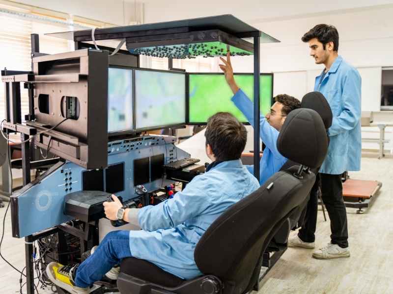 Young engineers working with advanced technology equipment demonstrating how innovation ecosystems contribute to building investor confidence.