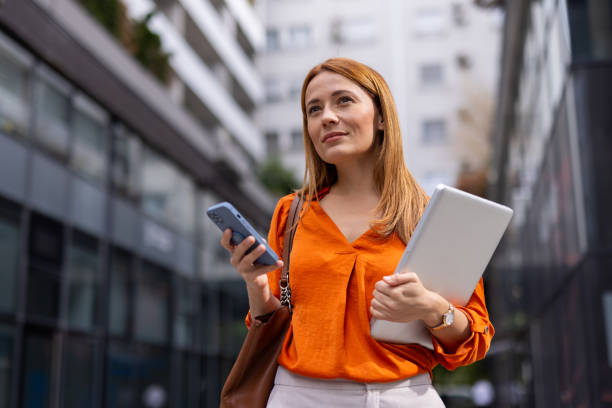 Businesswoman holding her phone confidently