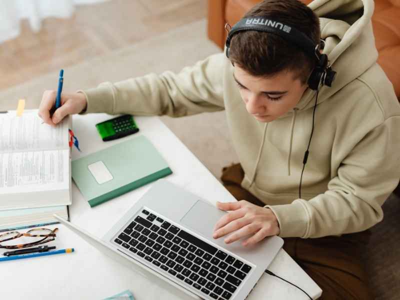 Student studying on a laptop representing scholarships, education access, and career readiness