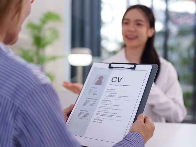 Job interview with a CV representing employability, skills, and education-based hiring