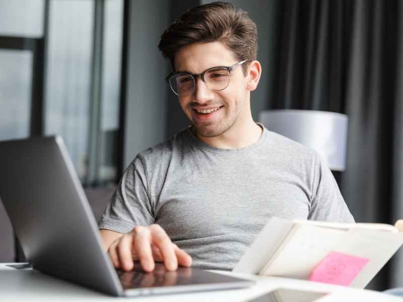 Young professional studying and working on a laptop representing disciplined entrepreneurship and continuous learning