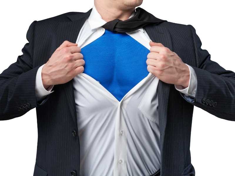 Businessman opening his shirt like a superhero, symbolizing leadership strength and decisive action in chaos.