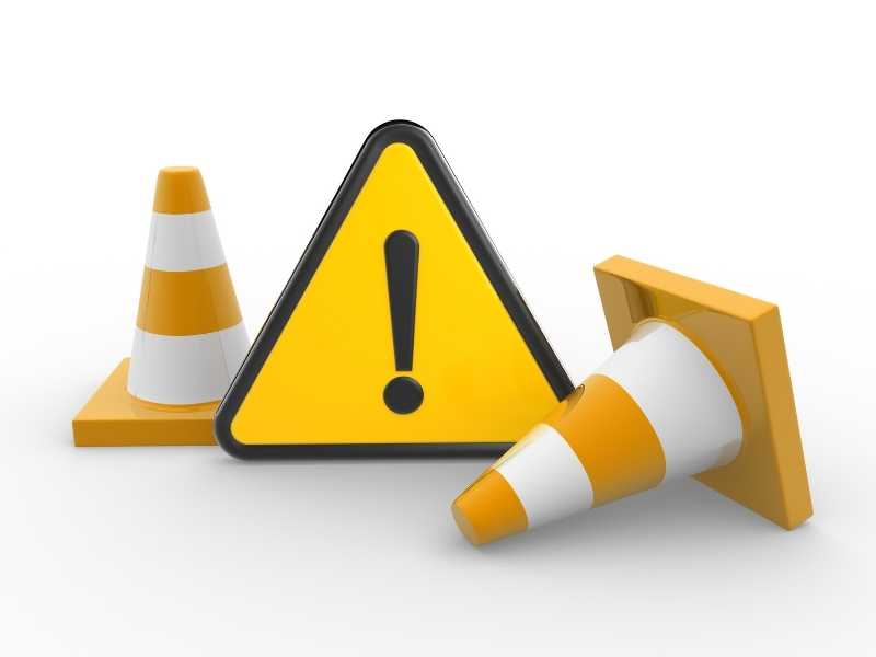 Warning sign with traffic cones, symbolizing financial risk and caution for long projects.