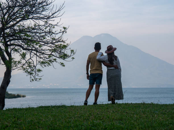Couple on the lakeshore, volcano view, Guatemala