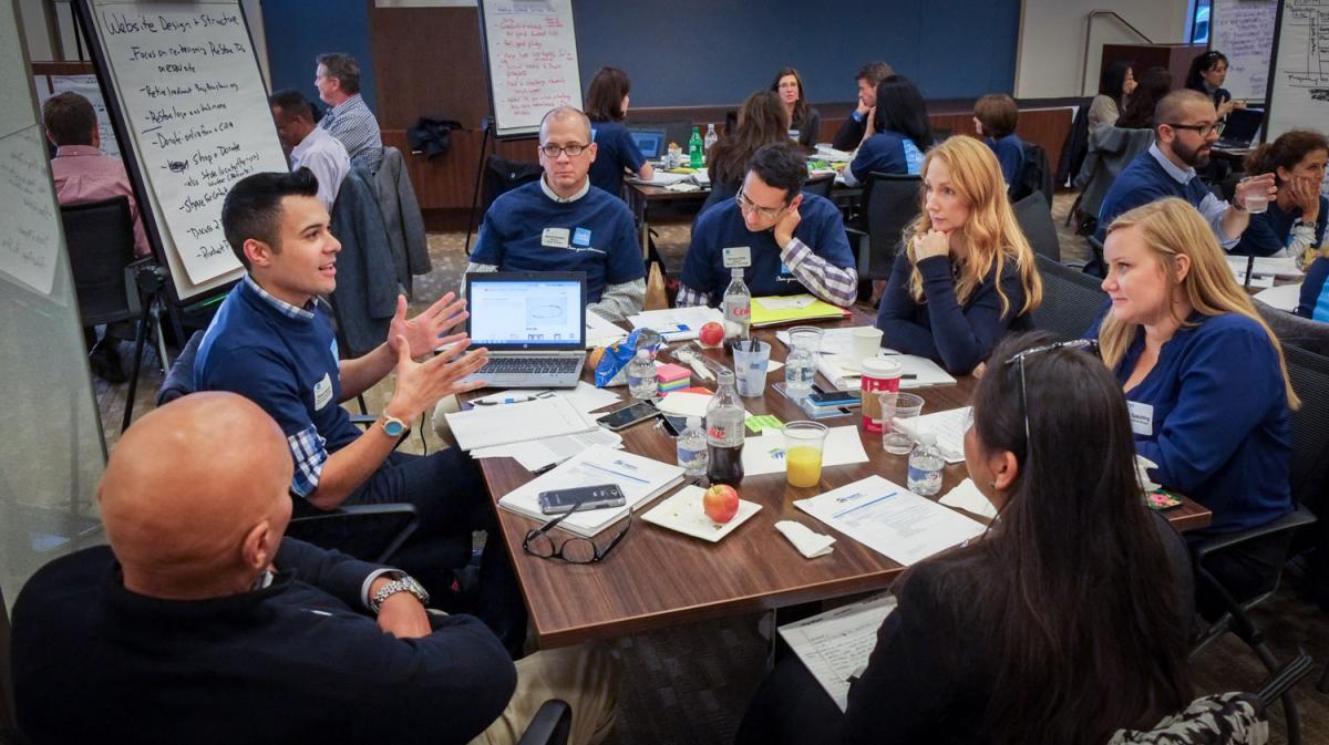 Professionals collaborating on a skills-based volunteering project to support organizational needs and social impact